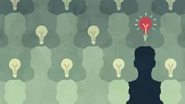 Silhouettes with light bulbs, one glowing red, symbolizing unique ideas.