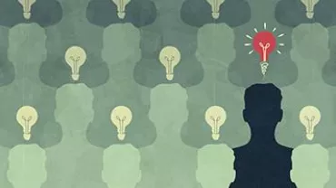 Silhouettes with light bulbs, one glowing red, symbolizing unique ideas.