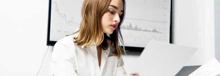 young female office employee looking at papers