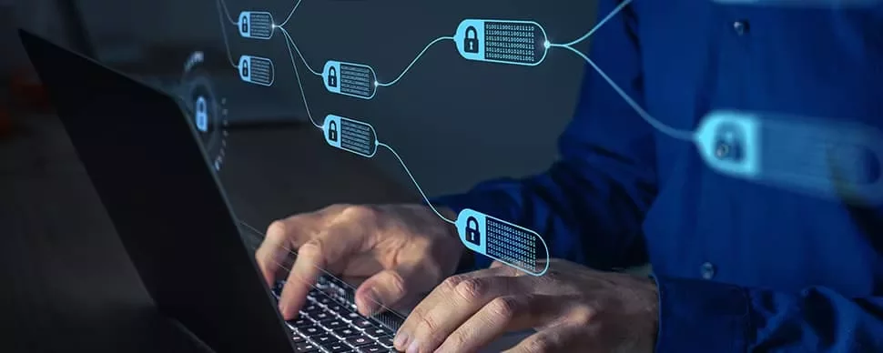 Person typing on a laptop with blockchain nodes shown as a digital overlay.