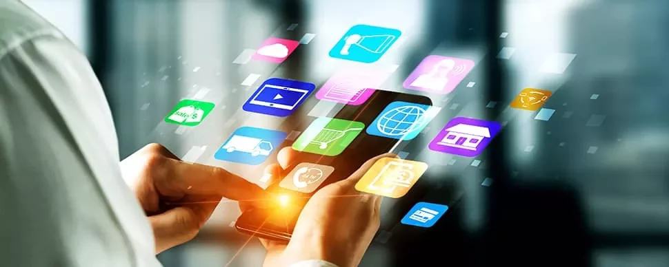 Person using a smartphone with colorful app icons floating above.