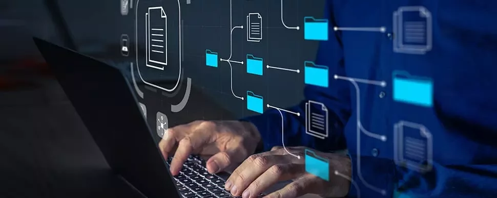 Person typing on a laptop with digital file icons overlay.