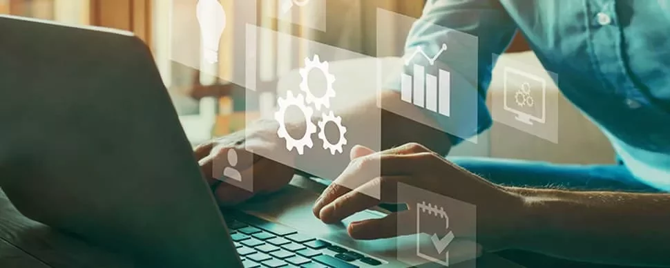 Person typing on laptop with digital icons like graphs and gears overlayed.