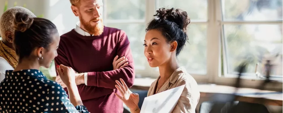 Group of professionals having a discussion in a bright office.