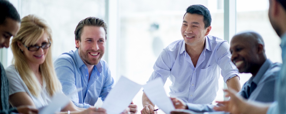 a group of white collar professionals of different races in a work environment