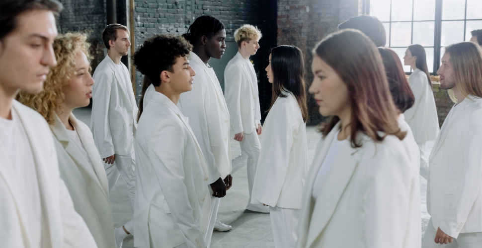 A big group of people wearing white blazers